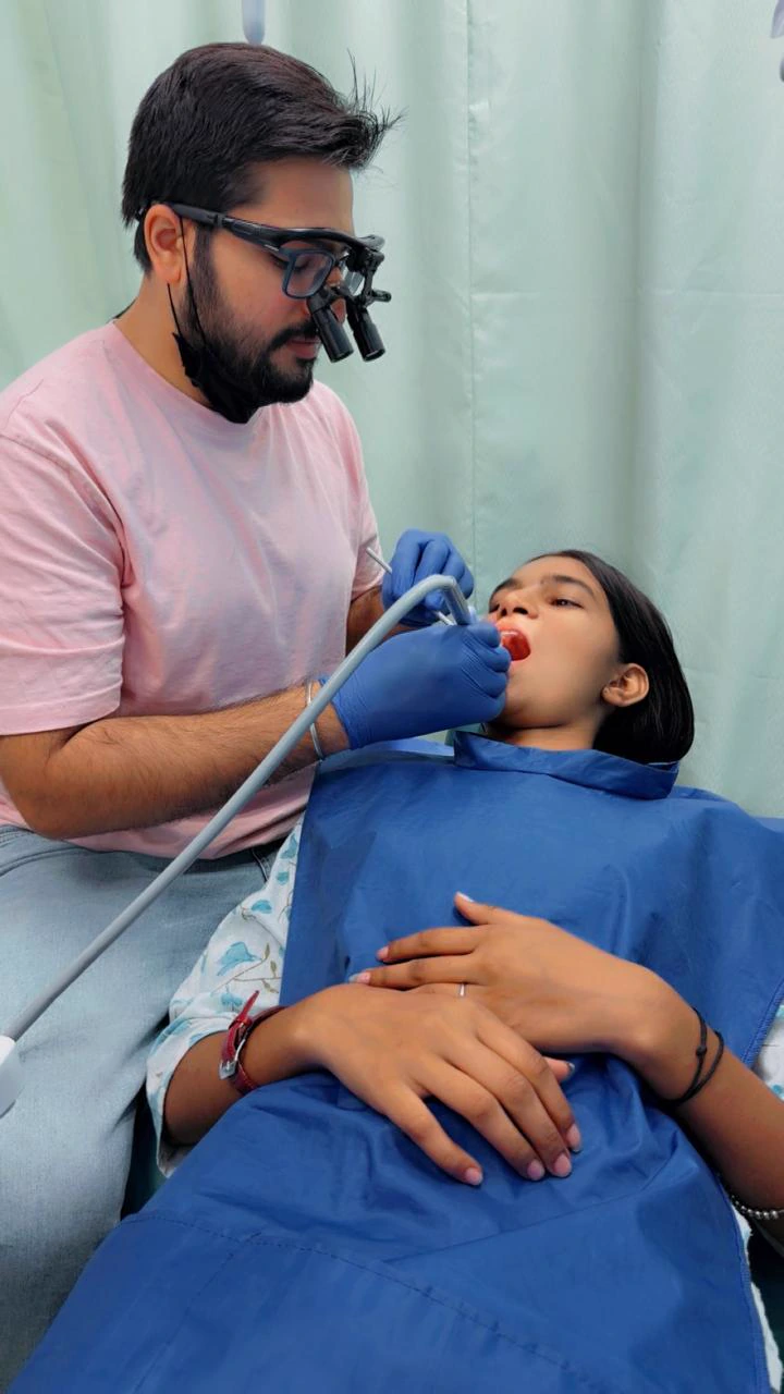 A dentist caring for a young patient during a dental visit