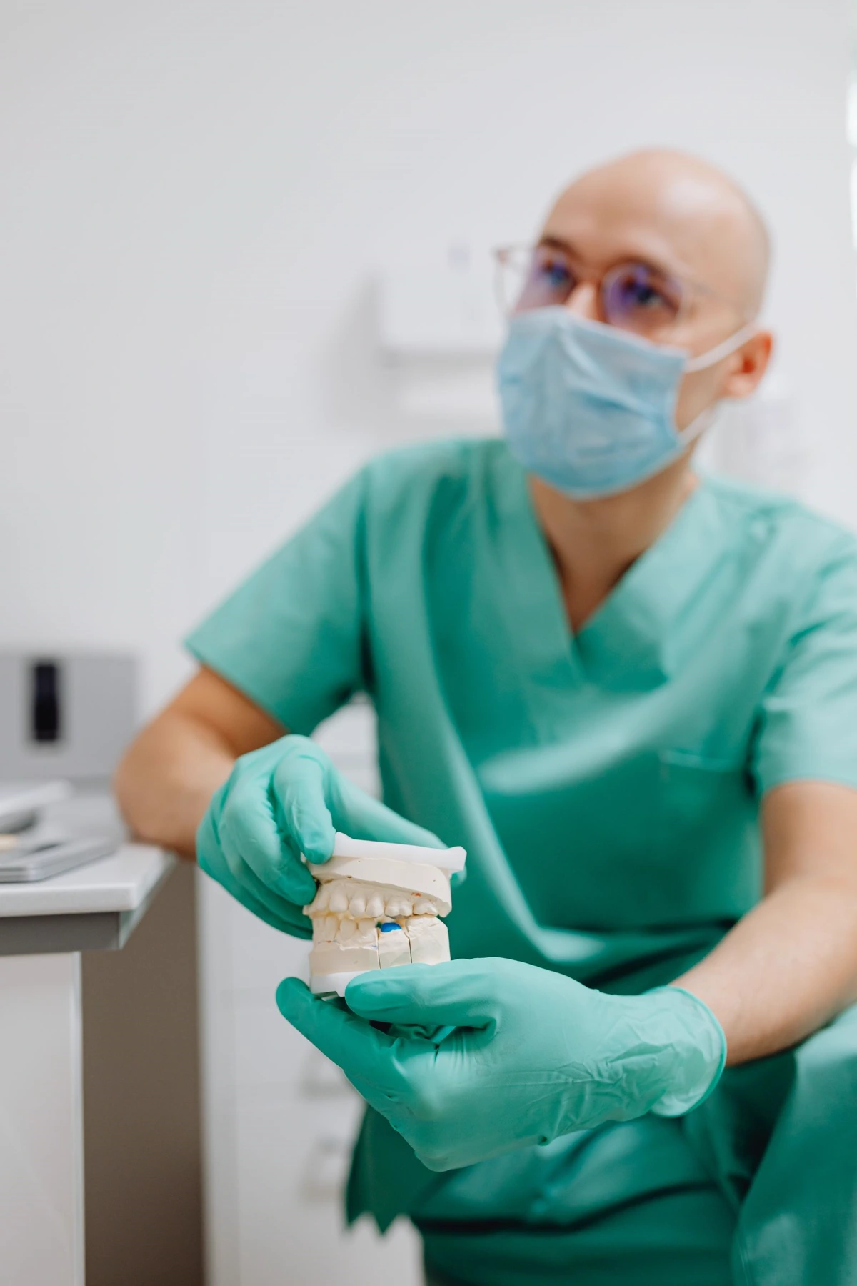 Dentist demonstrating a full-arch denture model