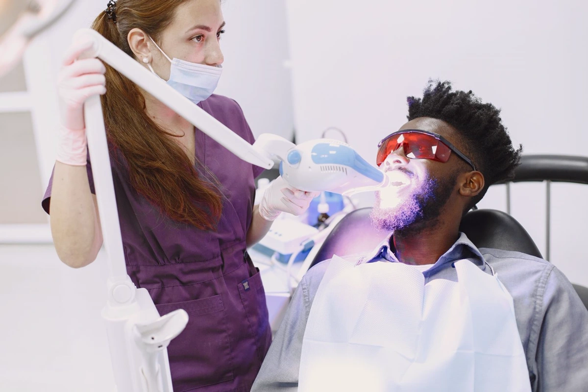 Patient receiving light-assisted teeth whitening